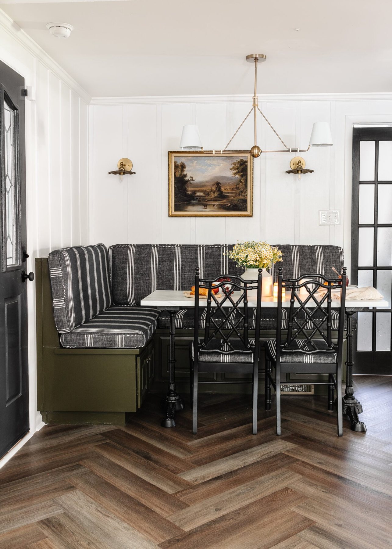 vintage corner breakfast nook with striped bench and herringbone floors from ProCore Floors