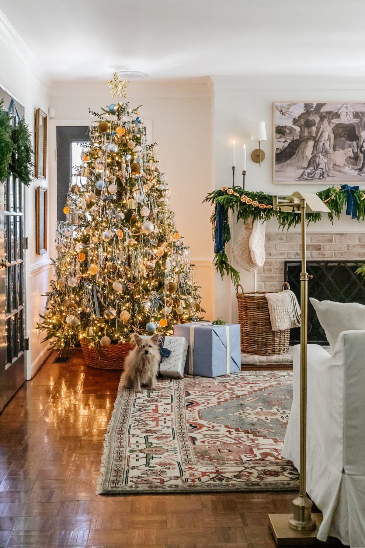 Christmas tree with tinsel in a living room and dog sitting
