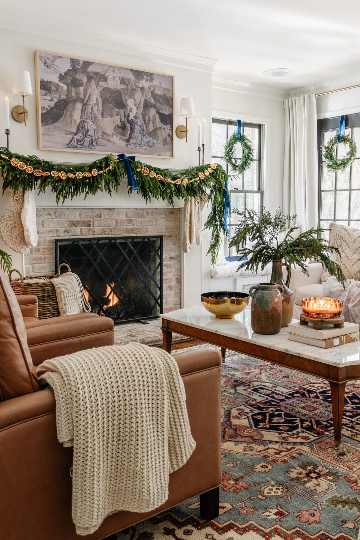 sweater knit blanket on leather chair in living room decorated for Christmas