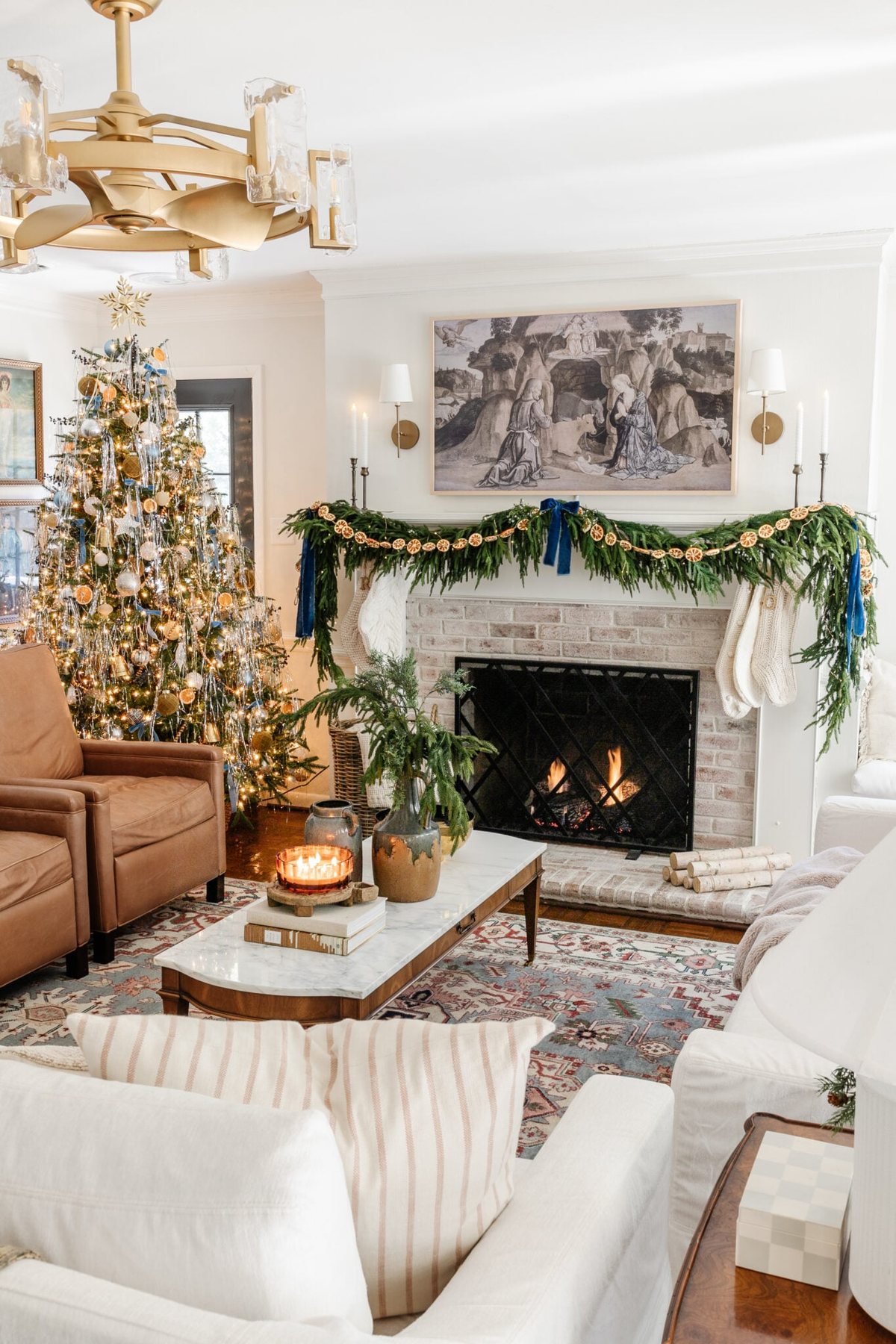 Living room decorated for Christmas with cozy candles and greenery