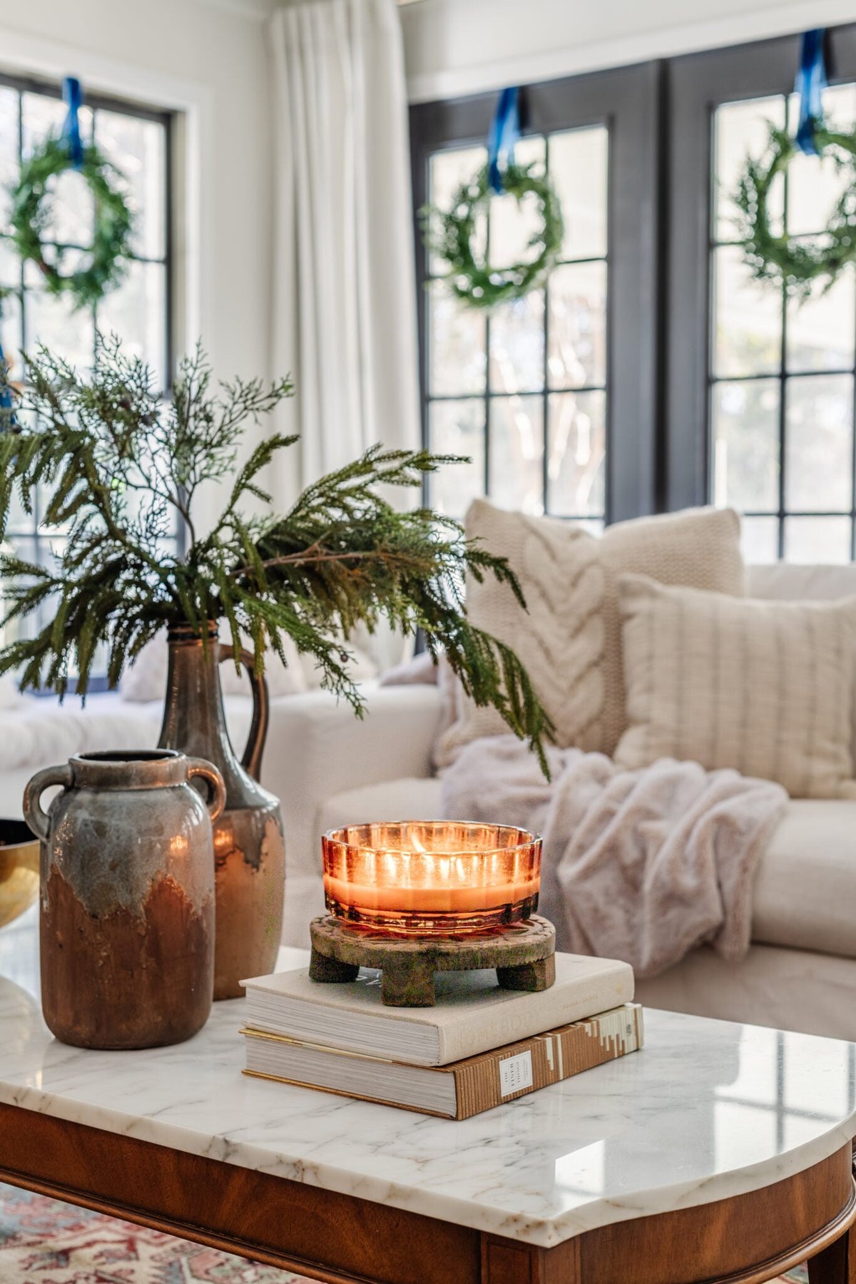 candle and winter decor on coffee table