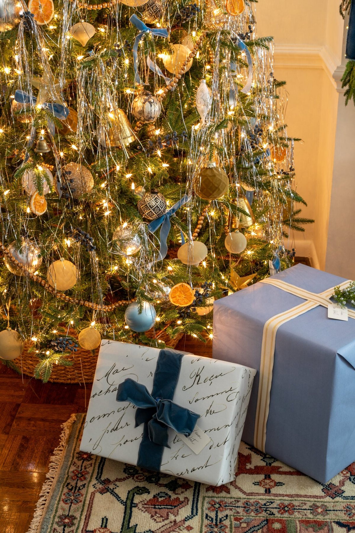 tinsel Christmas tree with blue and white wrapped presents