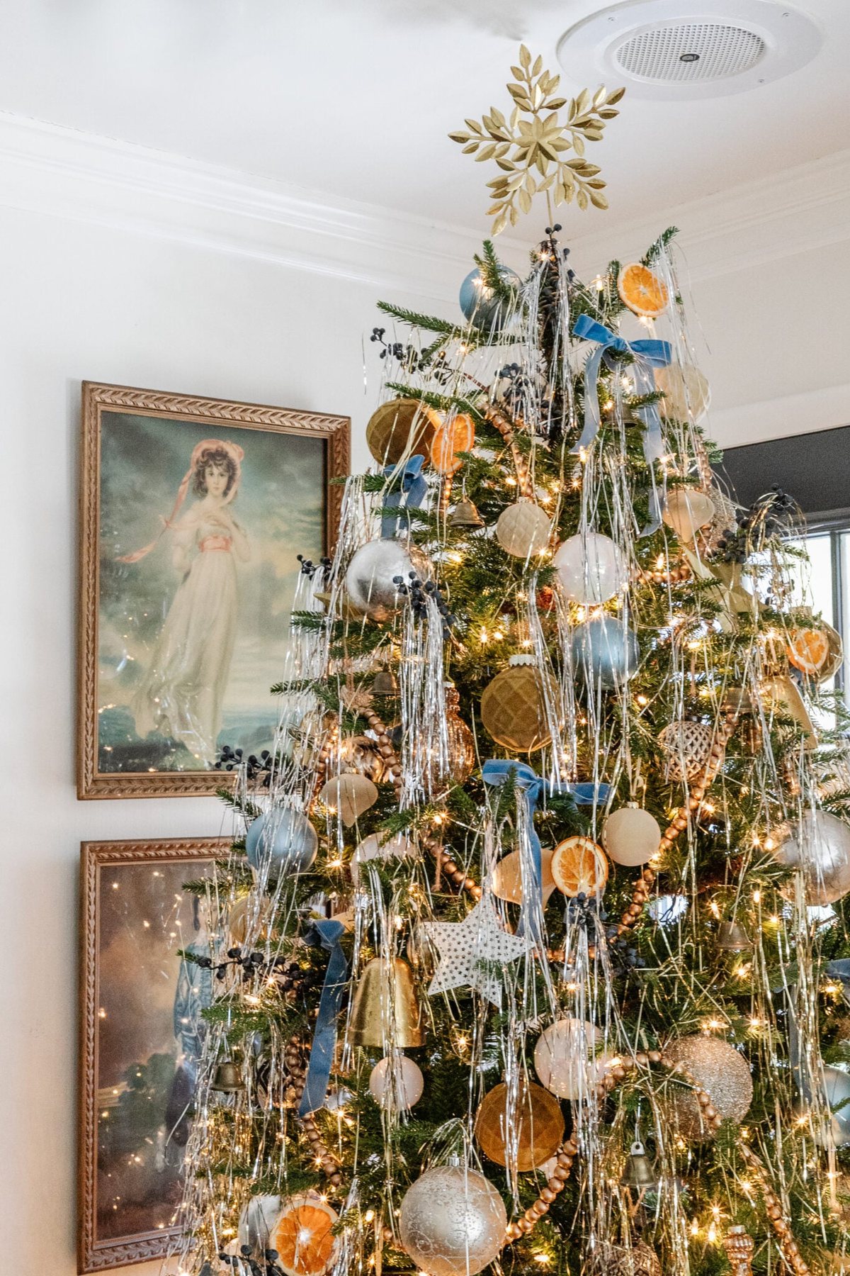 pinkie and blue boy art beside a Christmas tree