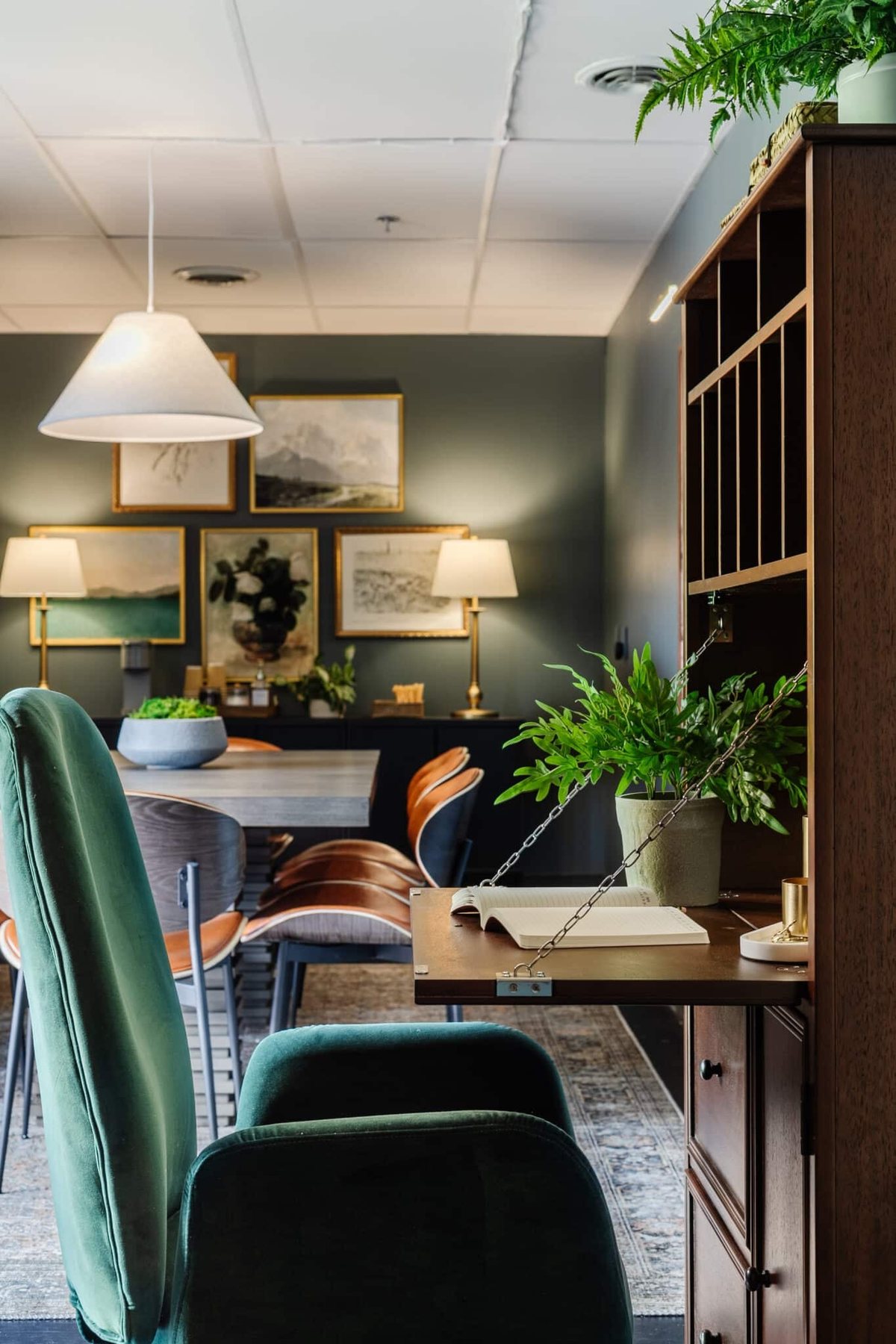 wooden secretary desk and green desk chair in an office