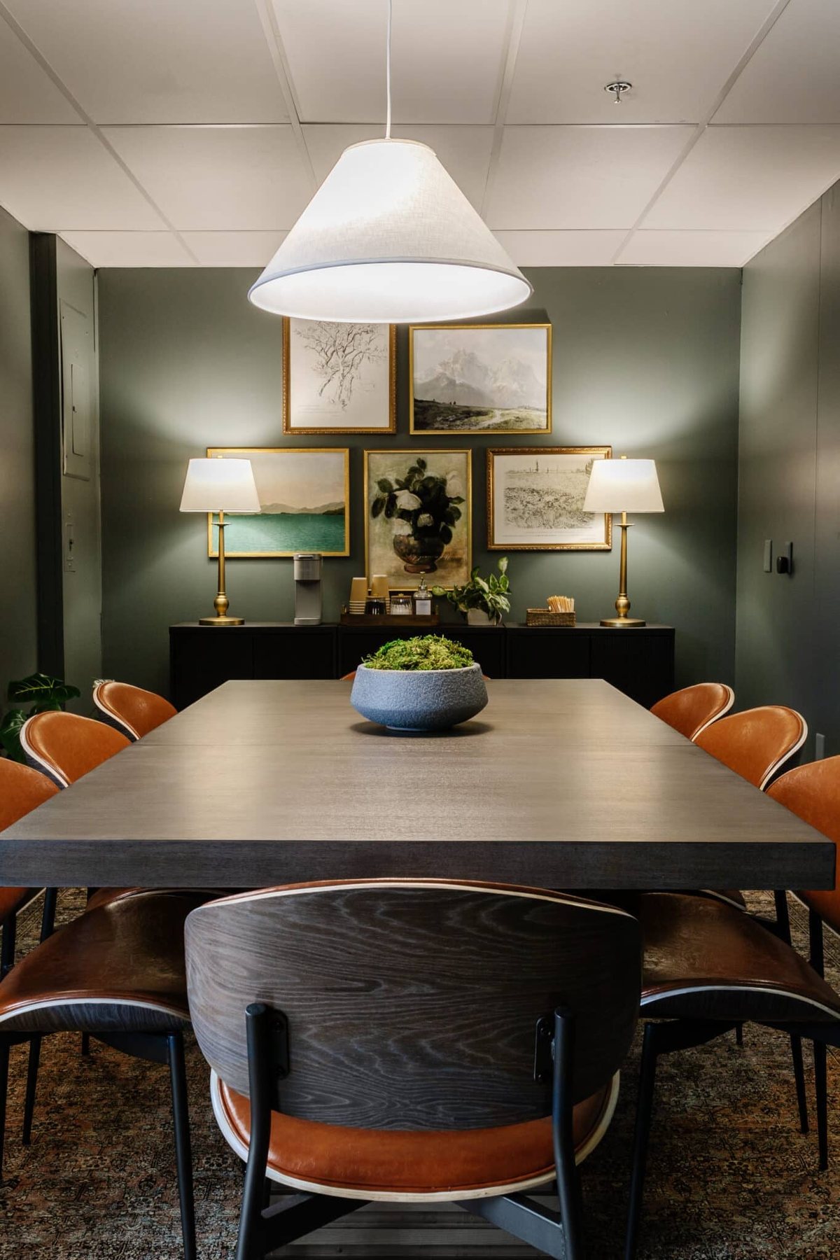 conference room lighting with cozy lamps instead of fluorescent bulbs with a conference table and chairs