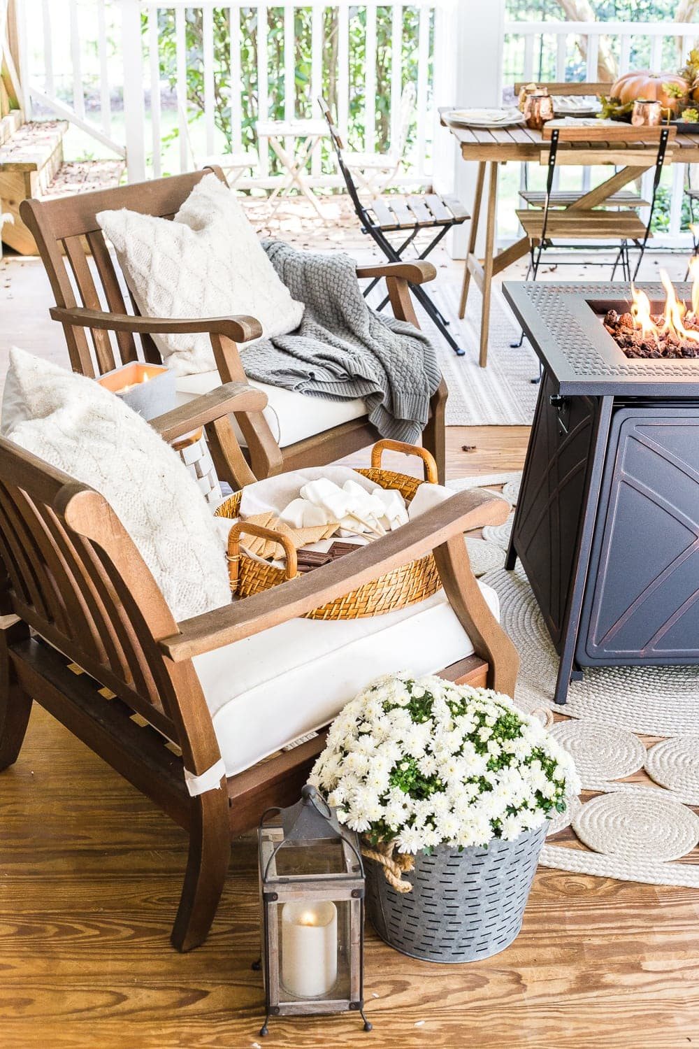 Cozy fall back porch with neutral outdoor furniture and fire pit