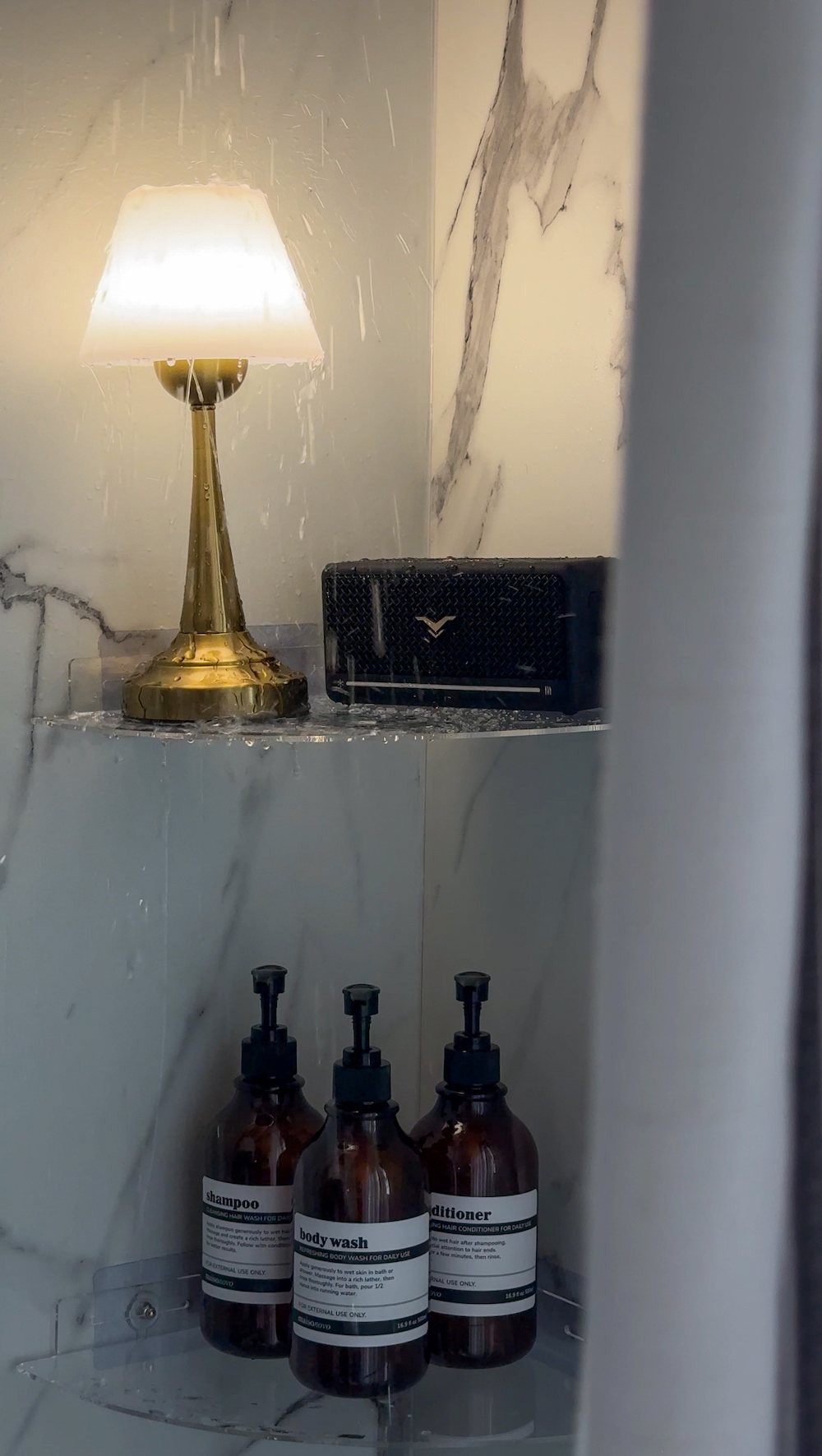 waterproof lamp on shower shelf with bluetooth speaker for a cozy bathroom