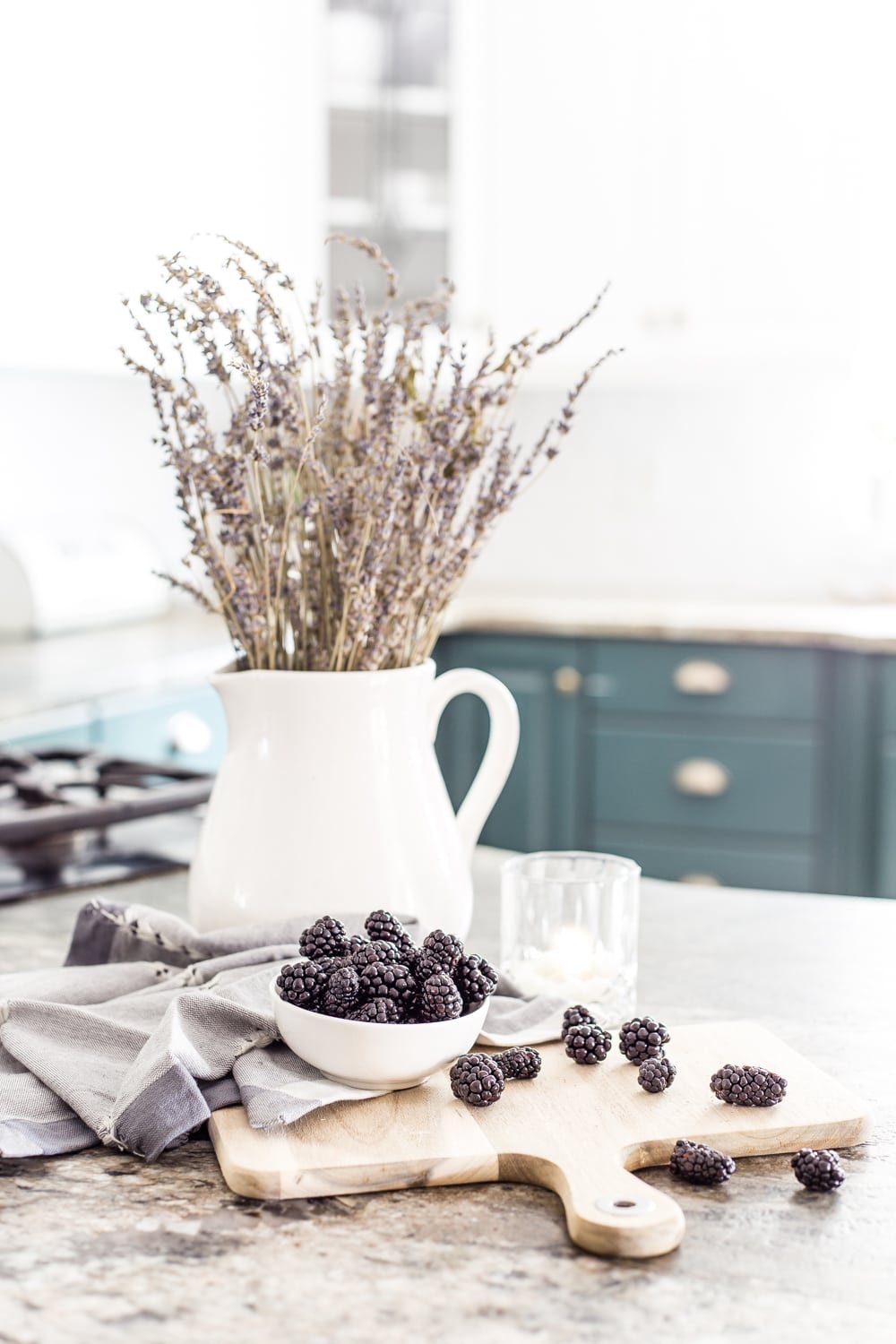pitcher of dried lavender on a kitchen countertop