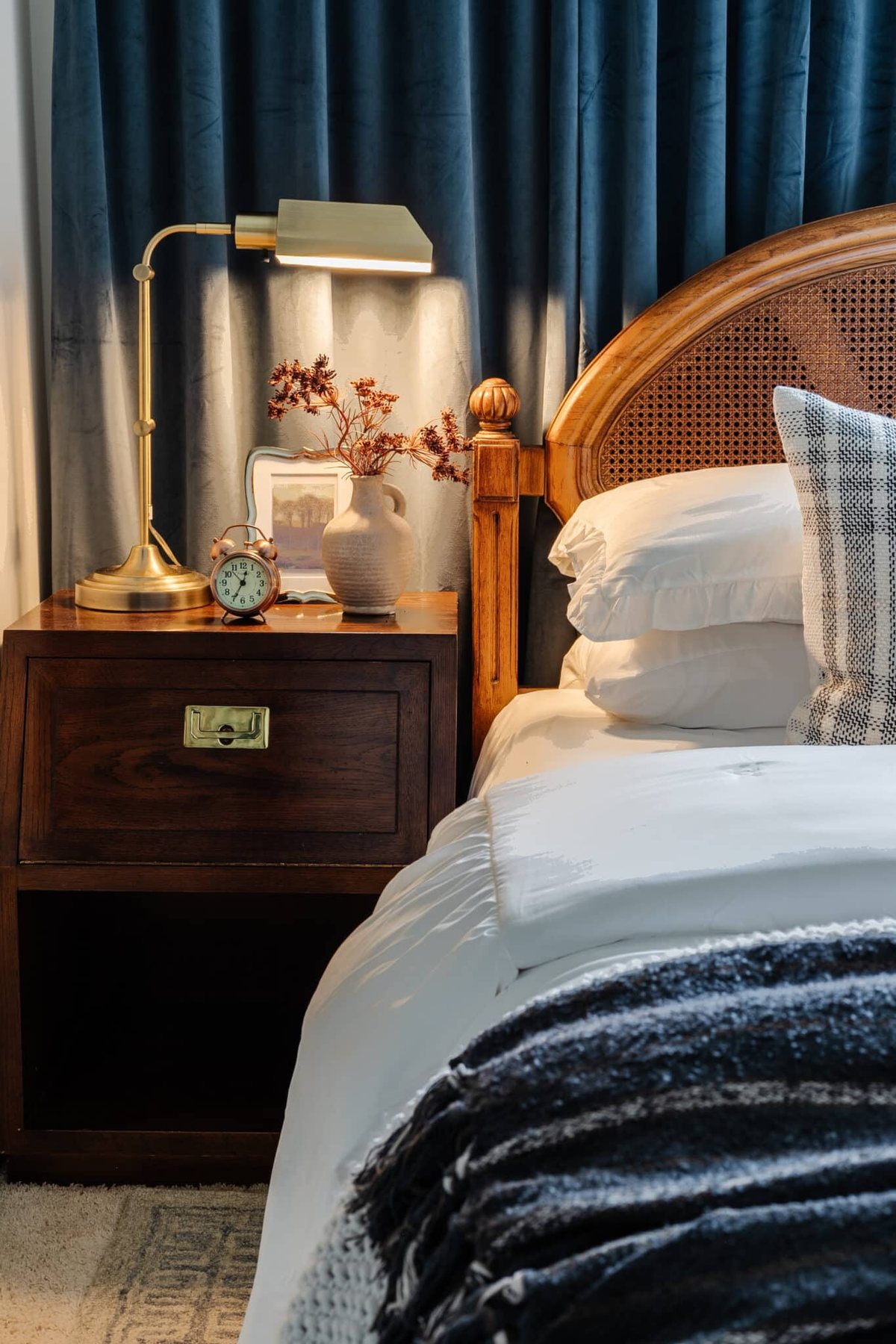 nightstand in a guest bedroom with pharmacy lamp
