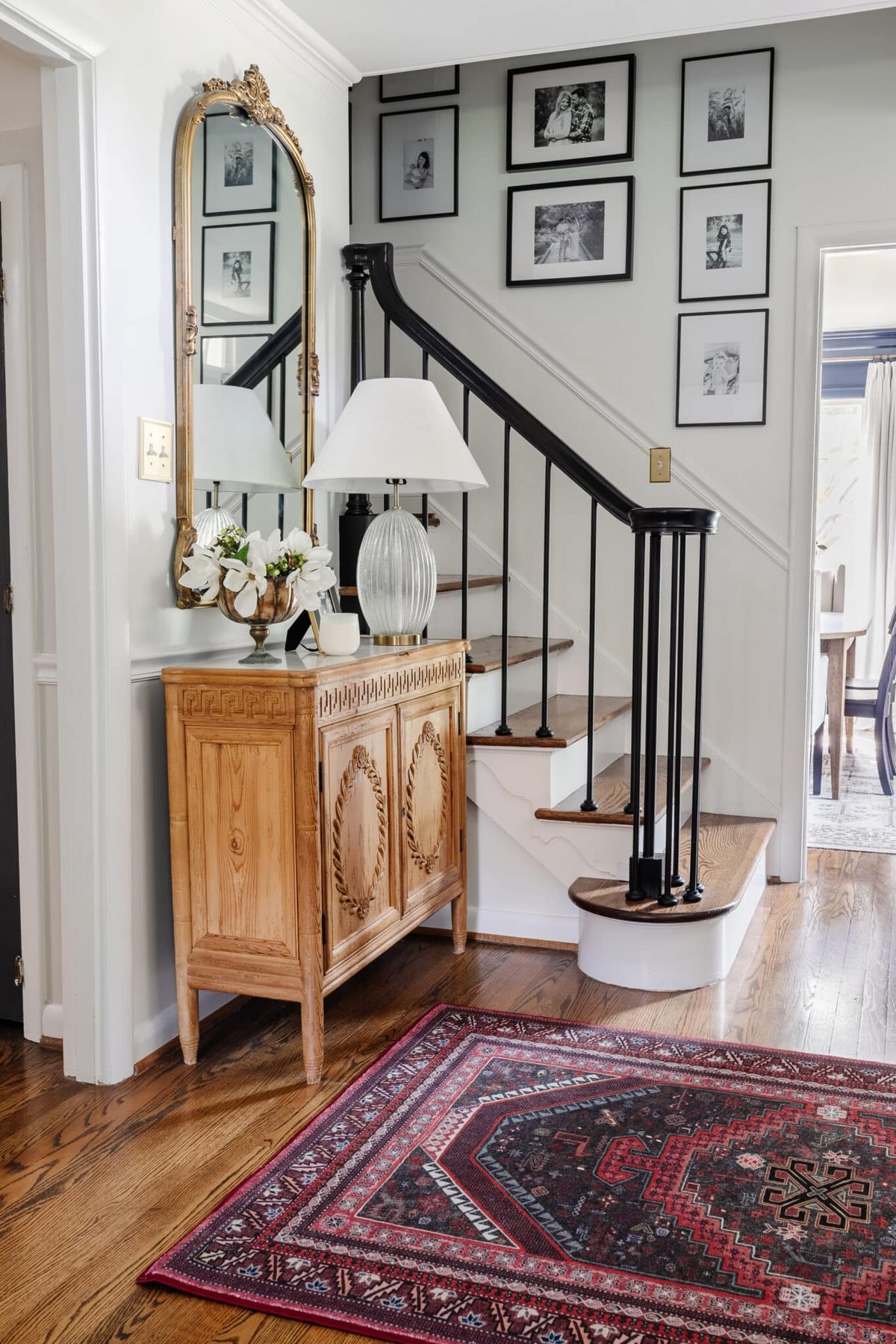 foyer and staircase with burgundy rug