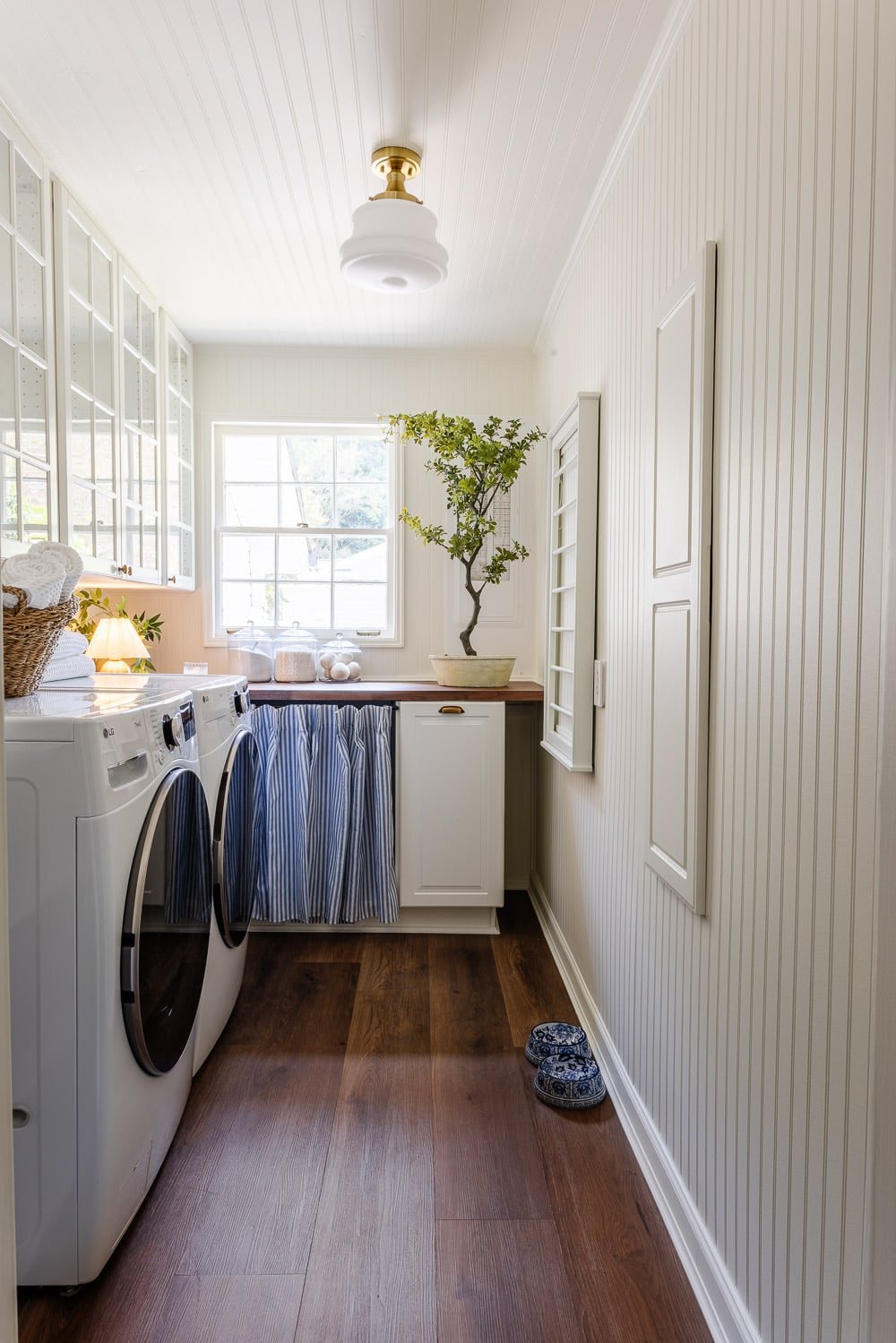 narrow laundry room layout with IKEA cabinets with vintage Nancy Meyers style