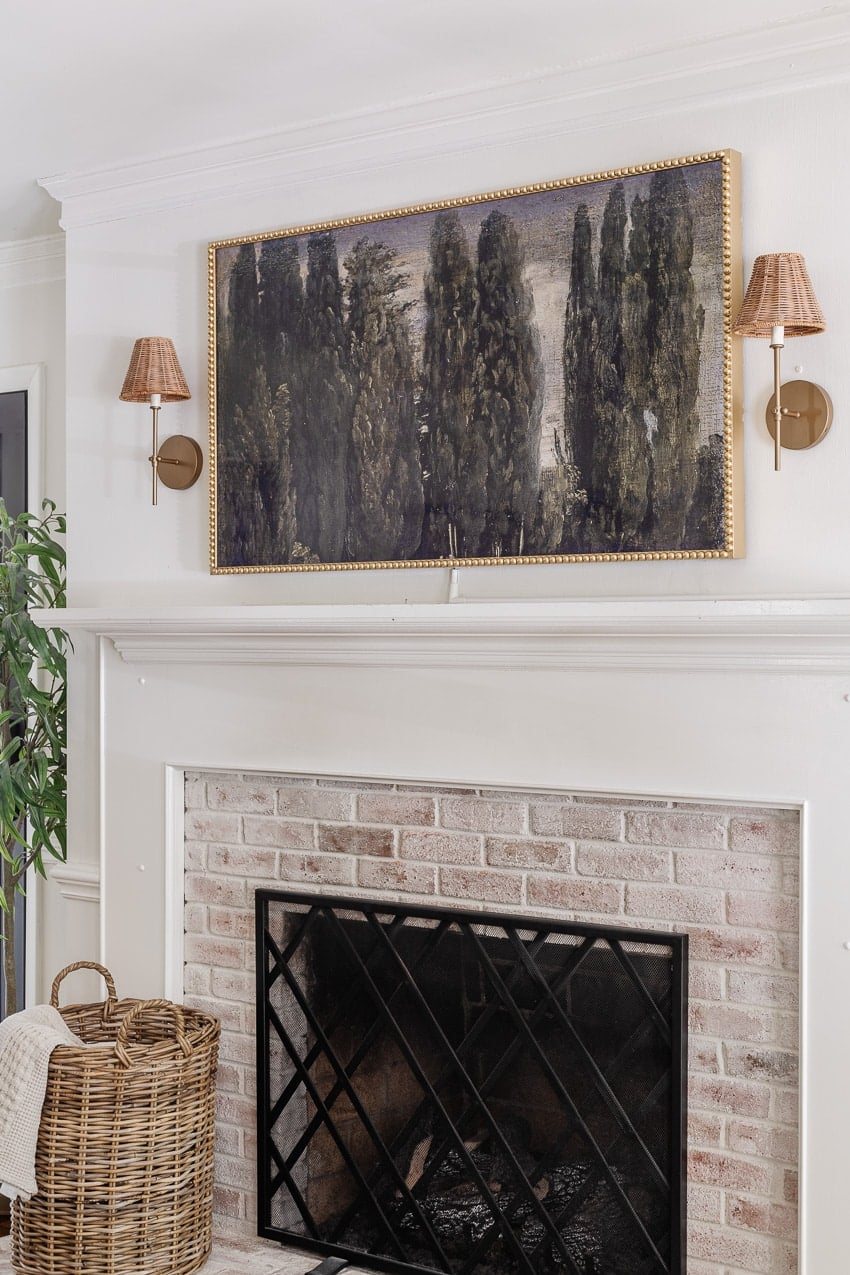 DIY bobbin frame on a Samsung frame TV + rattan sconces above a limewashed brick fireplace