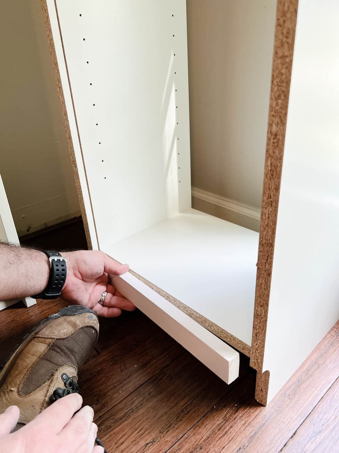 adding a 1x2 to the back of a bookcase to fill a gap to make diy built in bookshelves