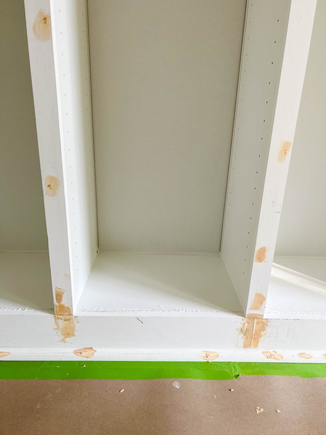 wood filler, caulk, and Loctite foam covering gaps, cracks, and nail holes