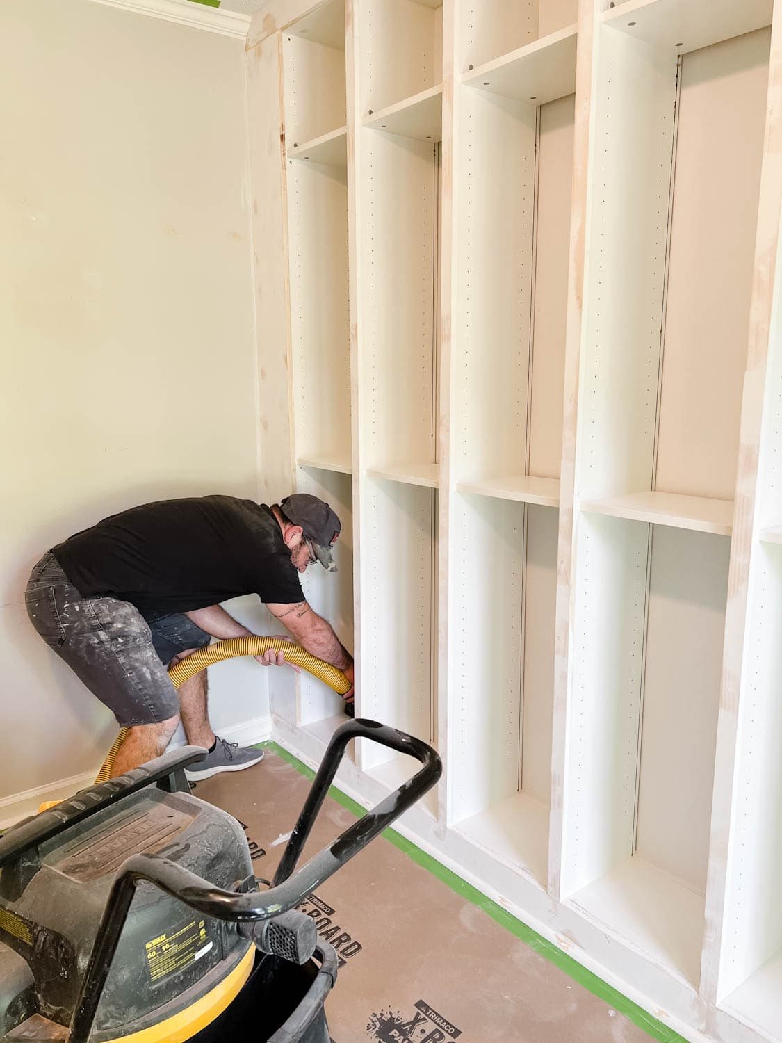 using a shop vac to remove sanding dust from shelves