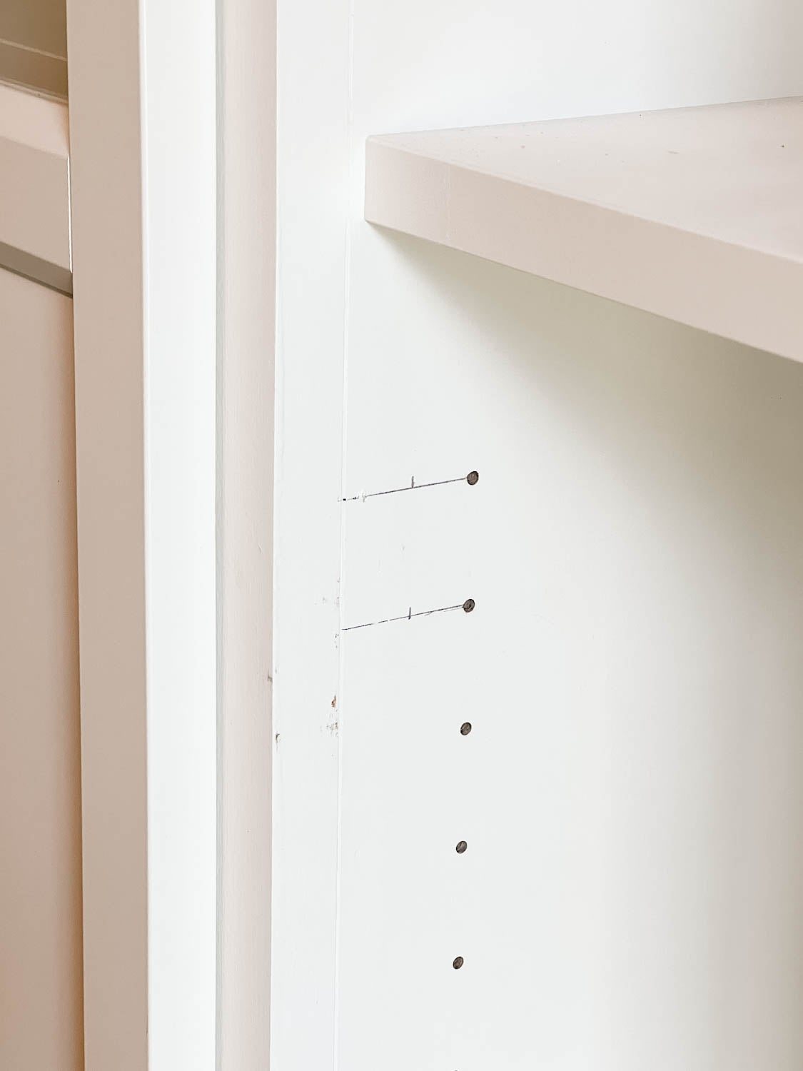 new holes marked for drilling to hang shelf doors