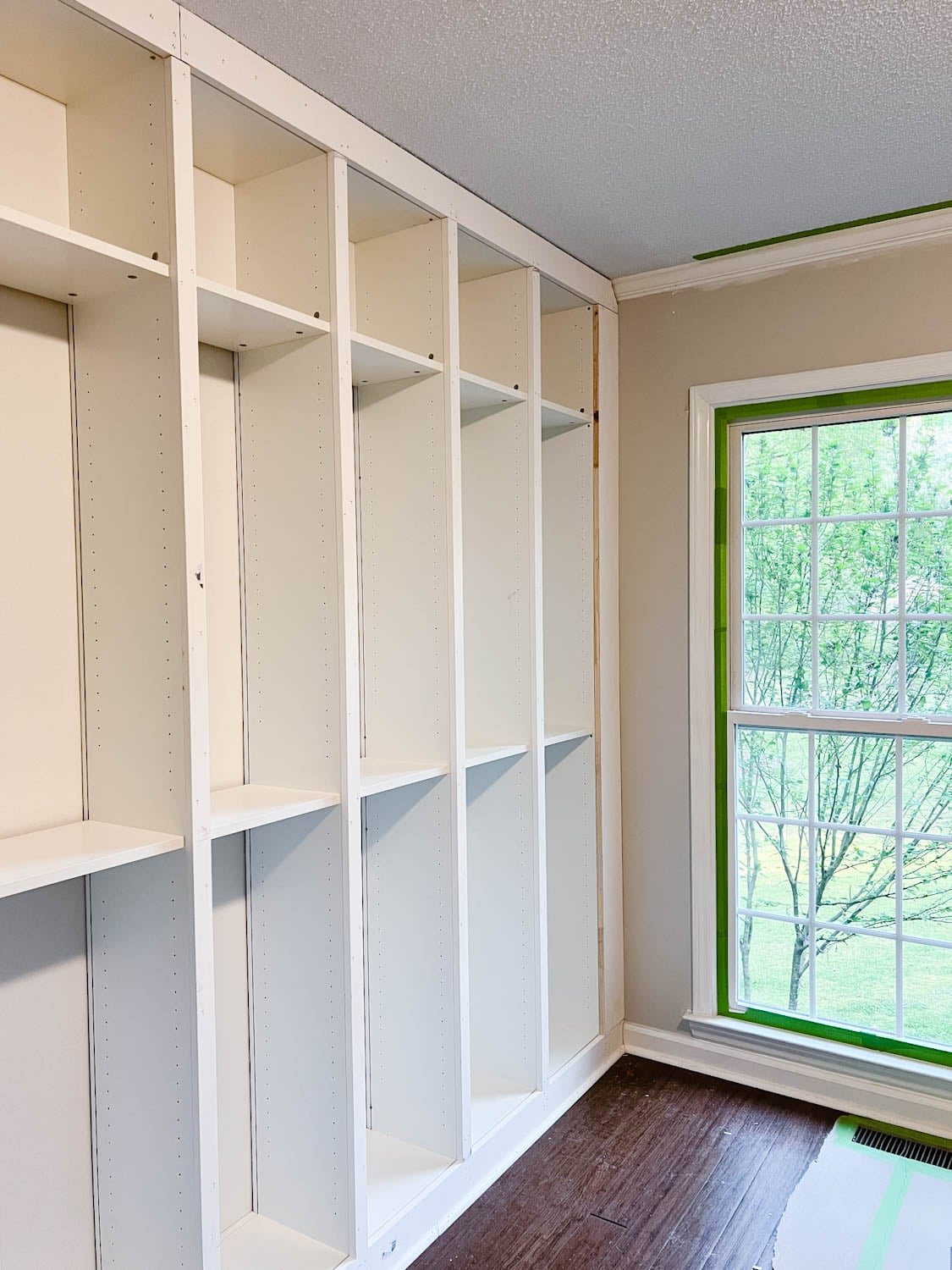 added 1x2 boards to the fronts of bookcases to hide the cracks where they meet
