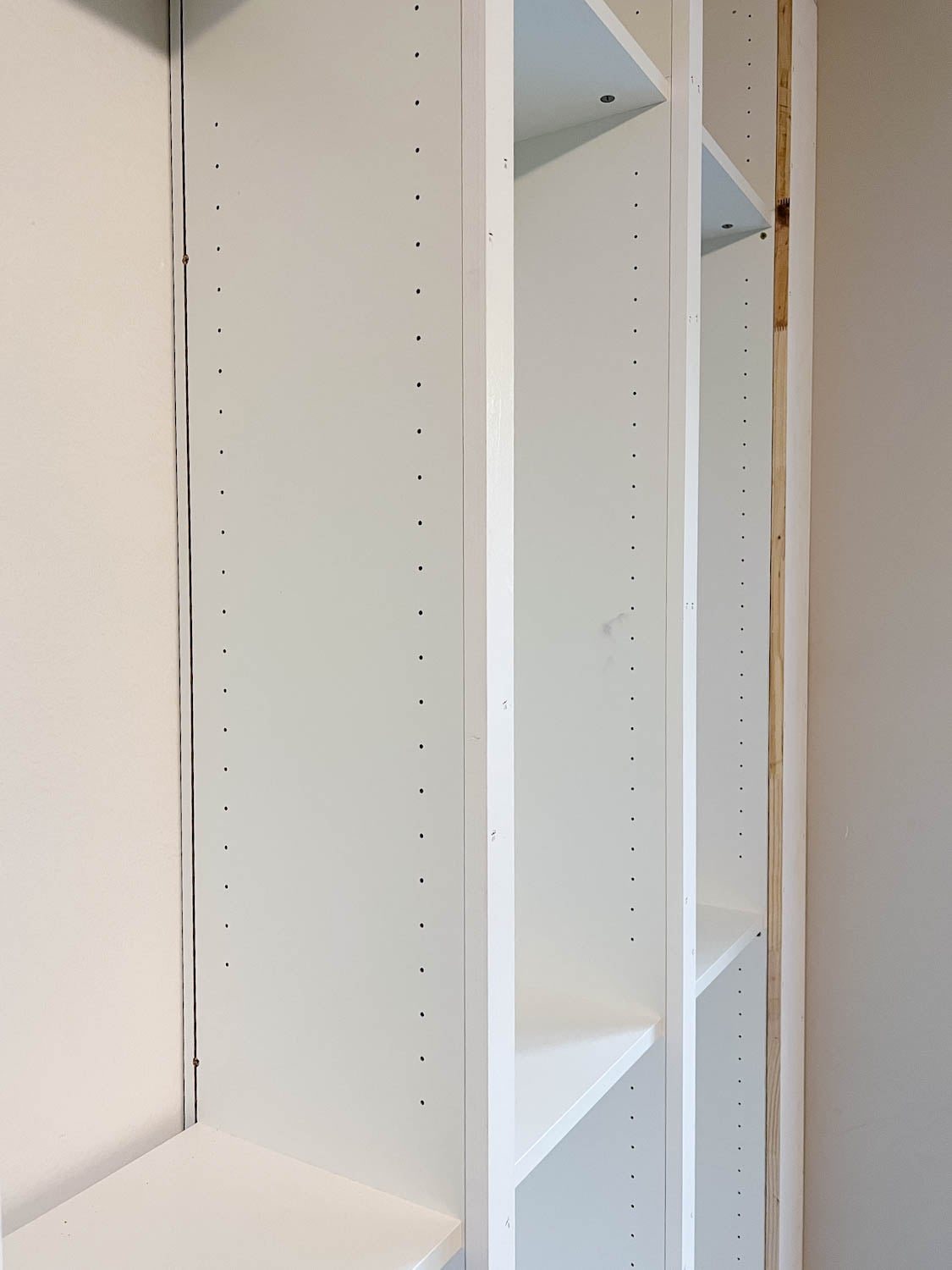 trimmed 1x10 board to fit the front of bookcases and fill the gap to make them look built in for the IKEA Billy bookcase hack