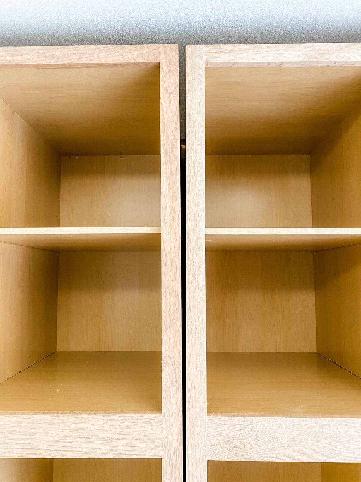 A step-by-step tutorial to build DIY built in cabinets and a window seat using inexpensive stock kitchen cabinets.