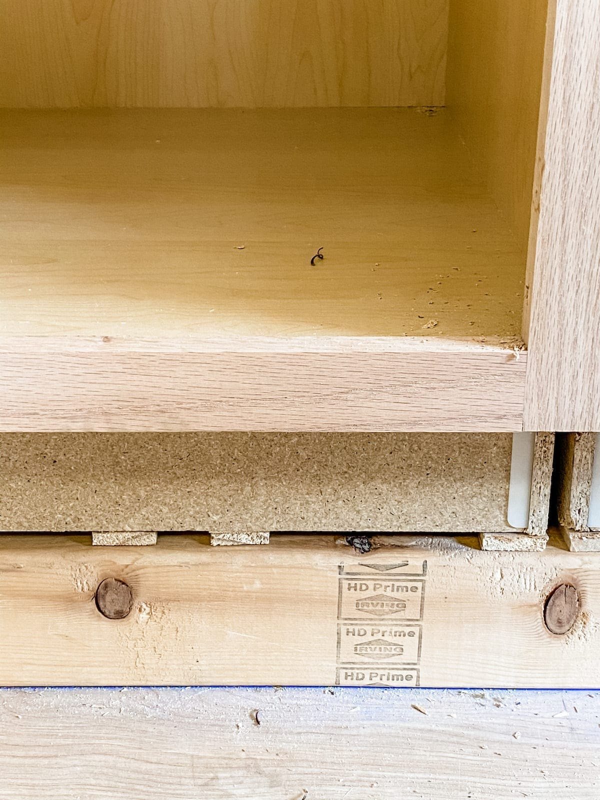 A step-by-step tutorial to build DIY built in cabinets and a window seat using inexpensive stock kitchen cabinets.