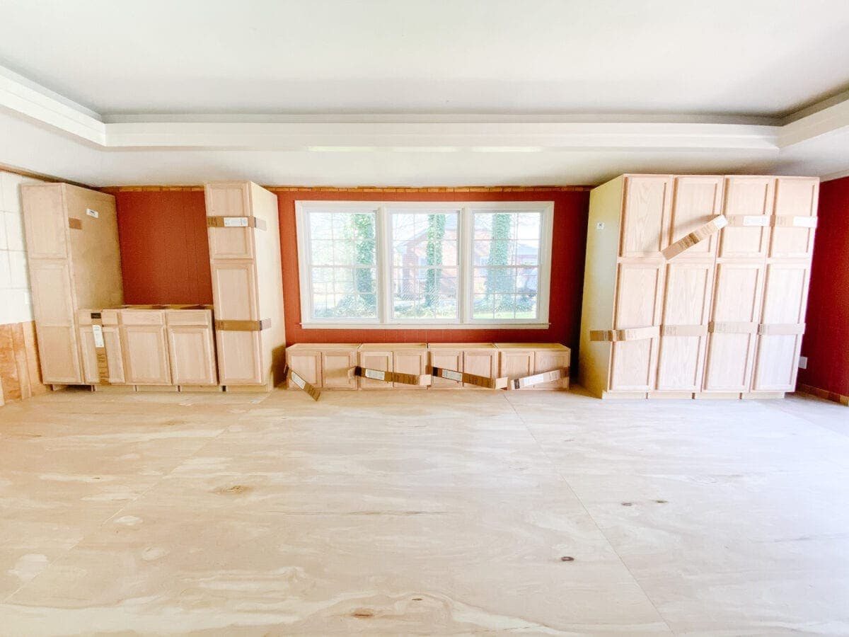 A step-by-step tutorial to build DIY built in cabinets and a window seat using inexpensive stock kitchen cabinets.