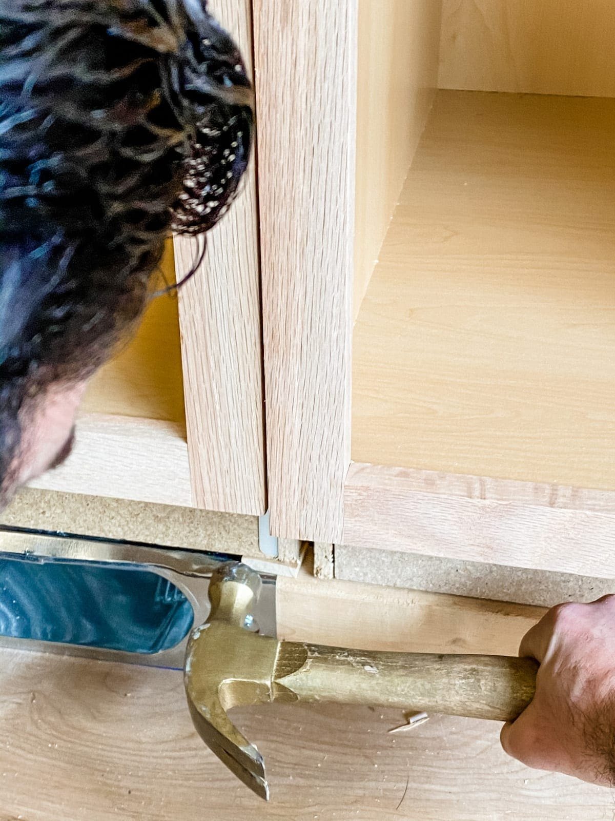A step-by-step tutorial to build DIY built in cabinets and a window seat using inexpensive stock kitchen cabinets.