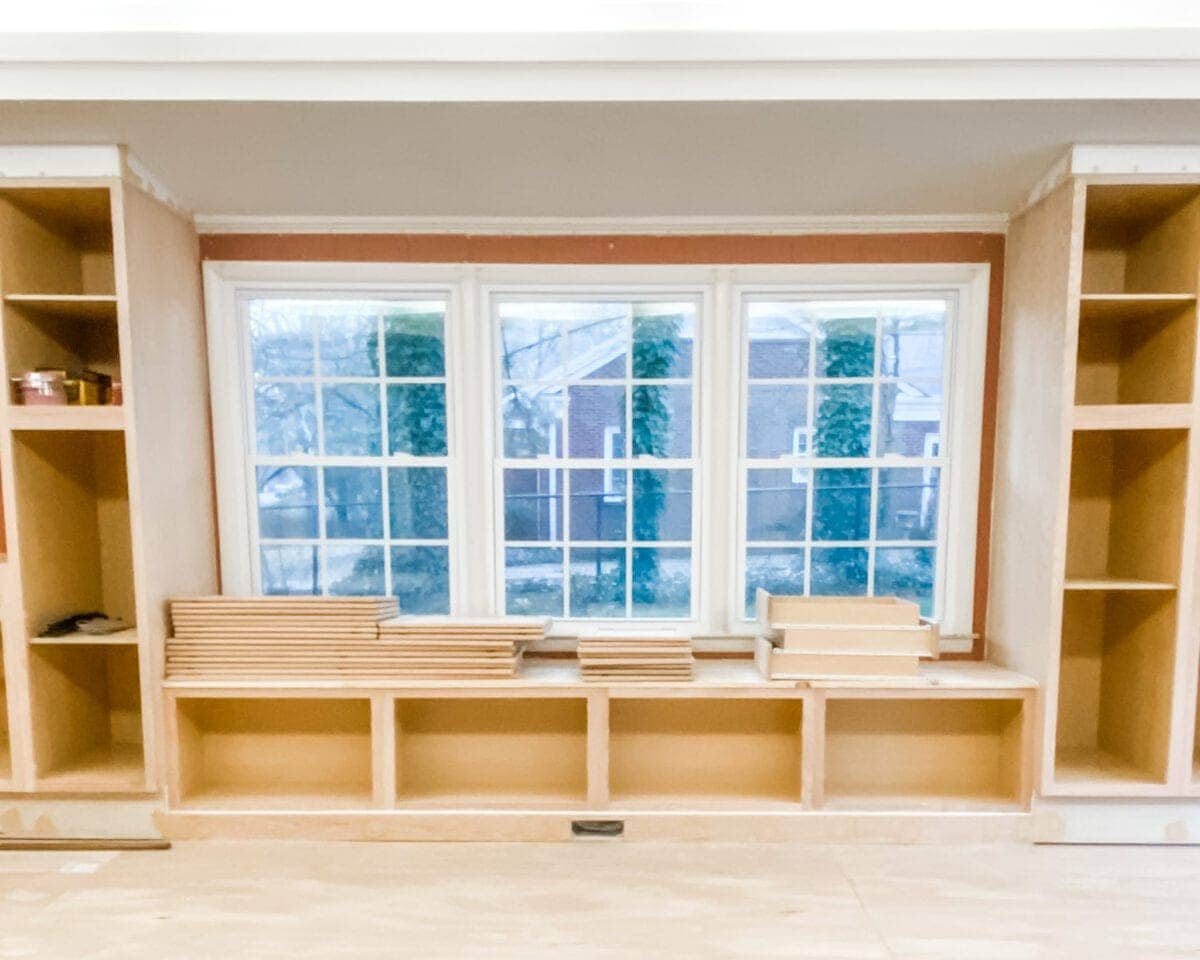 A step-by-step tutorial to build DIY built in cabinets and a window seat using inexpensive stock kitchen cabinets.