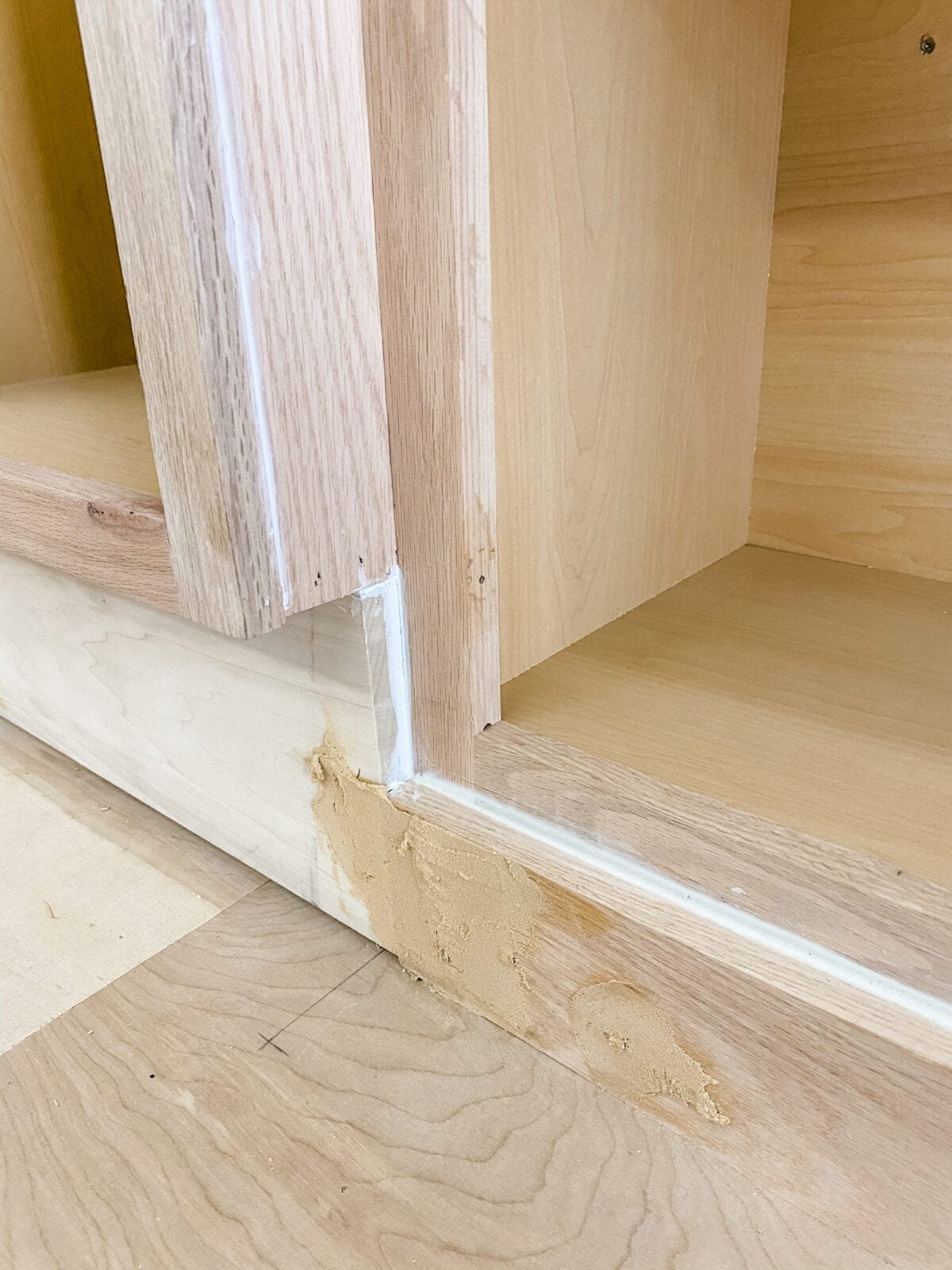 A step-by-step tutorial to build DIY built in cabinets and a window seat using inexpensive stock kitchen cabinets.