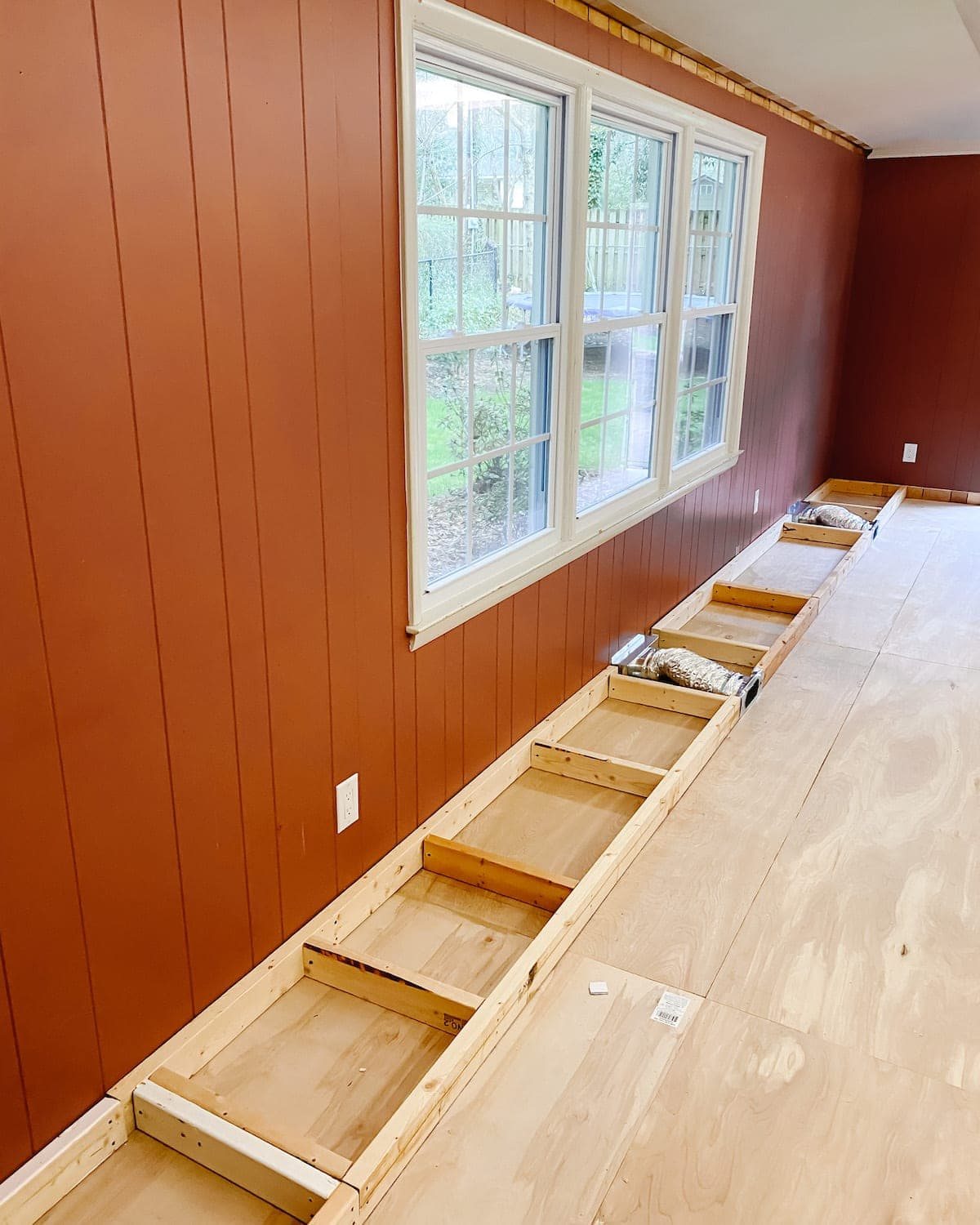 A step-by-step tutorial to build DIY built in cabinets and a window seat using inexpensive stock kitchen cabinets.