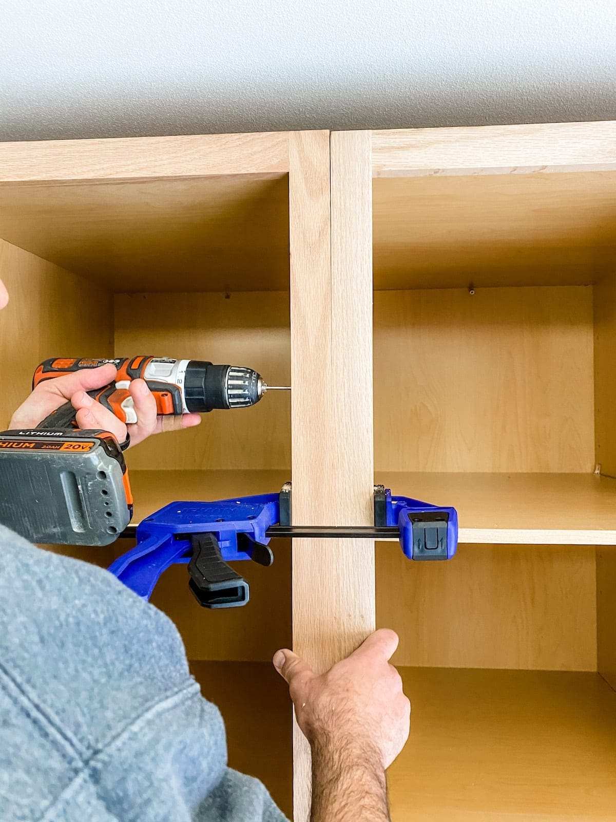 A step-by-step tutorial to build DIY built in cabinets and a window seat using inexpensive stock kitchen cabinets.