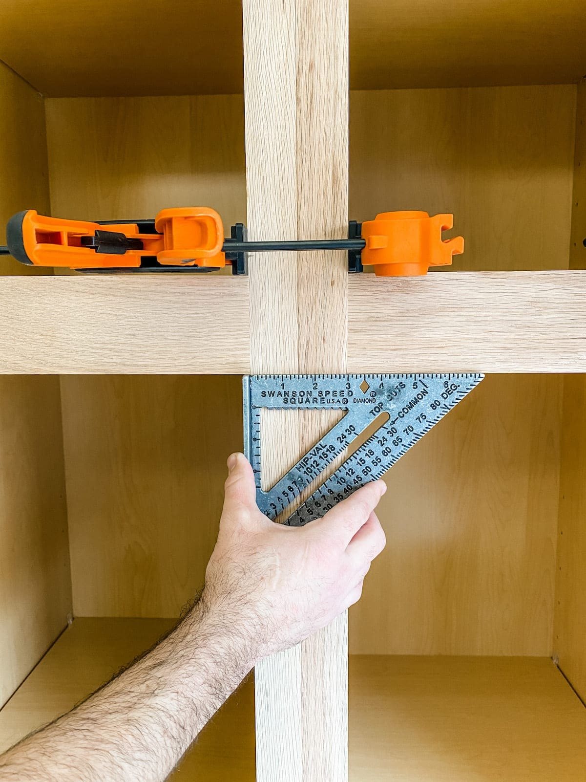 A step-by-step tutorial to build DIY built in cabinets and a window seat using inexpensive stock kitchen cabinets.