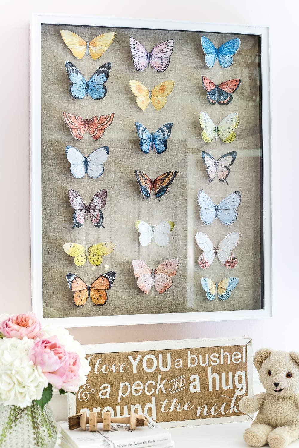 A tutorial about how to make an inexpensive modern Victorian style butterfly study shadow box with free printables of watercolor butterfly graphics for a little girl bedroom. #kidsdecor #girlbedroom #girlroom #kidsbedroom #wallart #kidsart #kidswallart #butterfly #butterflies #butterflydecor #girlydecor #nursery