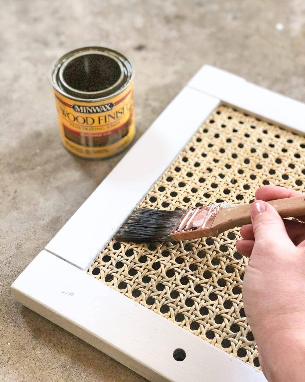 DIY Cane Nightstand Makeover | How to turn a basic glass cabinet nightstand into a designer-worthy cane style that works for both modern and traditional styles.