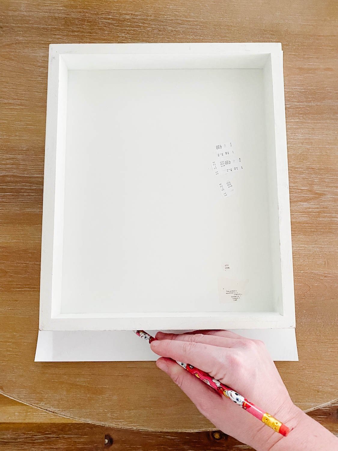tracing a frame onto a vintage art print to trim