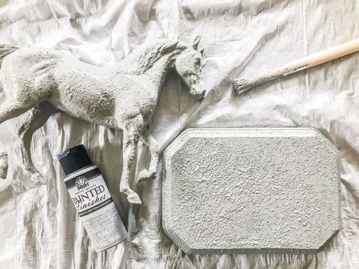 How to turn a toy horse figurine into a designer-inspired concrete equestrian statuette using just paint, wood craft, and glue. #thriftymakeover