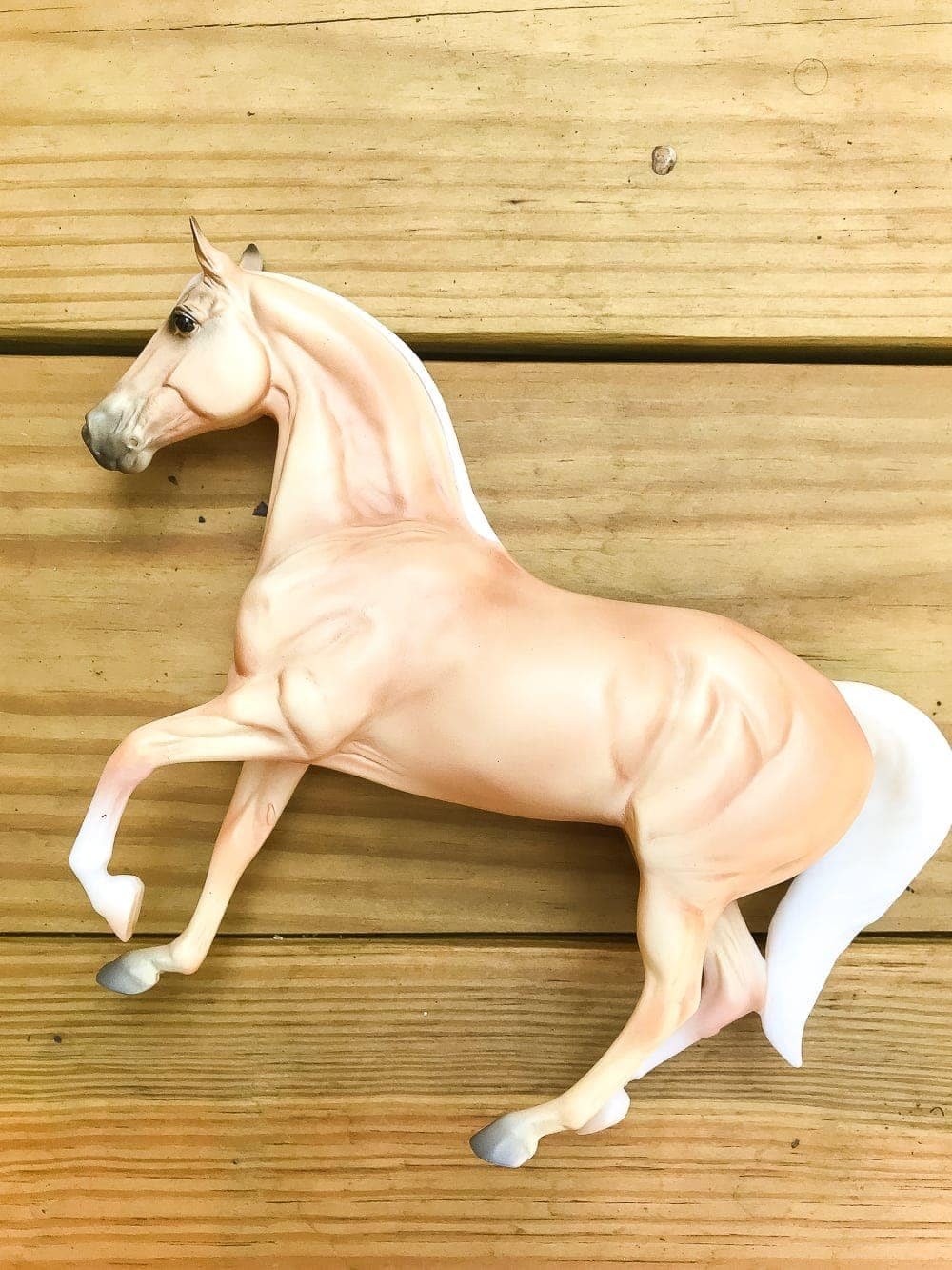 How to turn a toy horse figurine into a designer-inspired concrete equestrian statuette using just paint, wood craft, and glue. #thriftymakeover