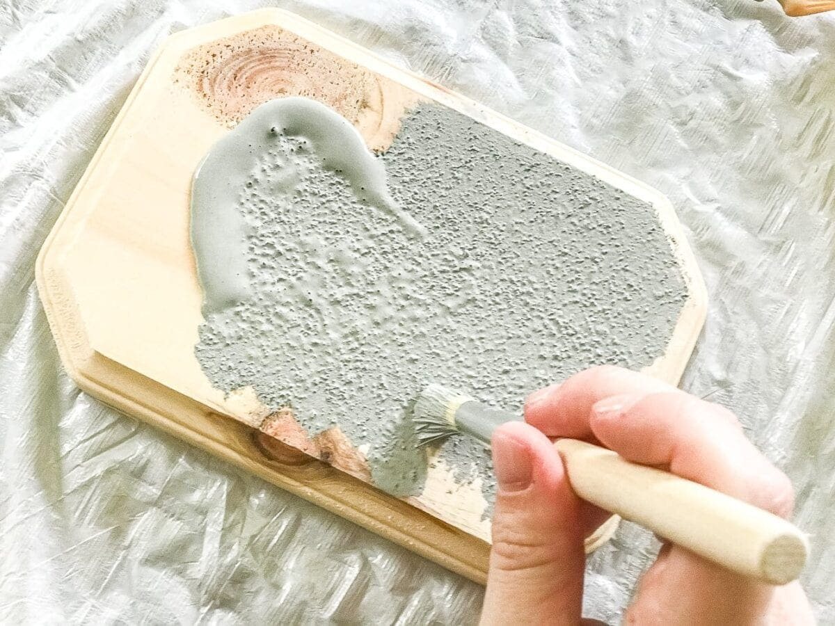 How to turn a toy horse figurine into a designer-inspired concrete equestrian statuette using just paint, wood craft, and glue. #thriftymakeover