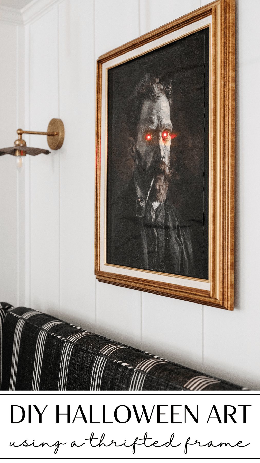 DIY creepy Halloween art in a thrift store frame with glowing eyes