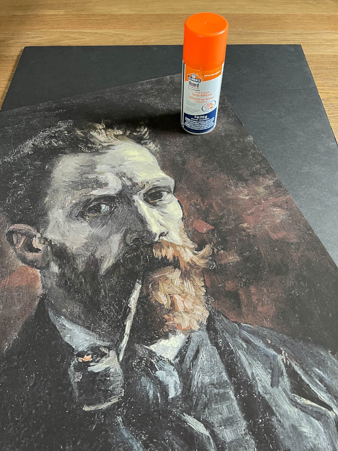 making creepy art by using spray adhesive on foam board