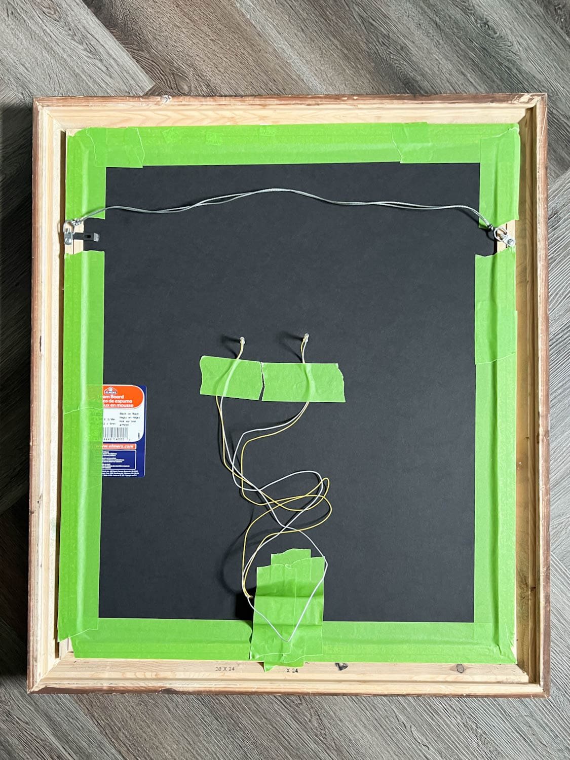 red battery lights taped to the back of a Halloween art portrait