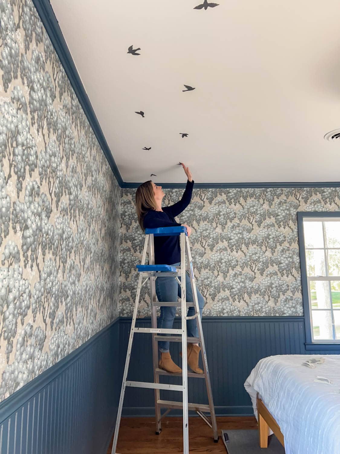 placing bird decals in a block print pattern to make fake ceiling wallpaper