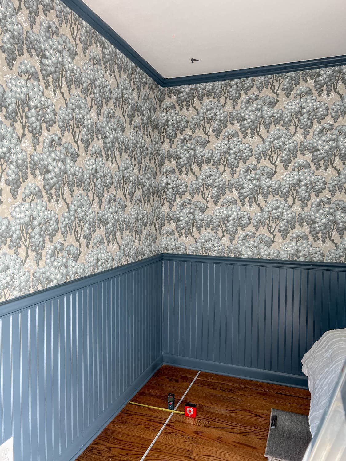 measuring a block print in a grid on a ceiling to make a faux ceiling wallpaper