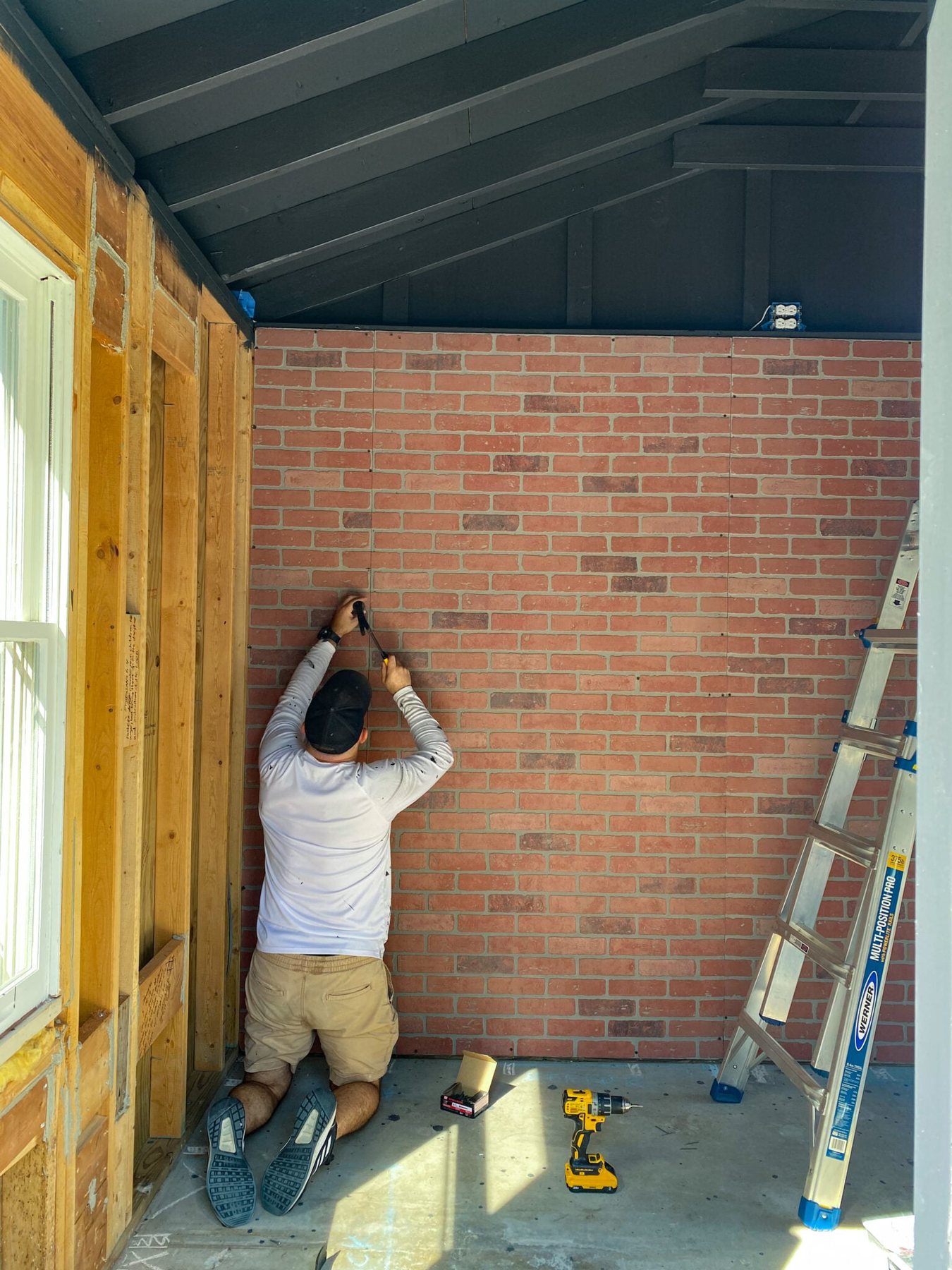 cutting and hanging faux brick wall panels