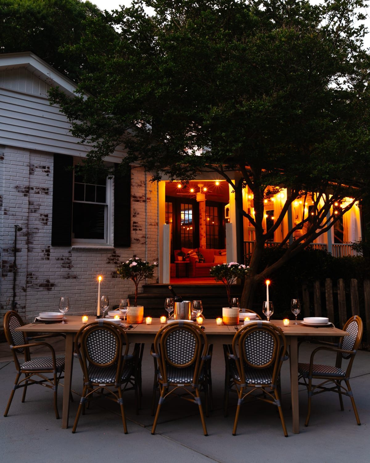 night time backyard patio and back porch with string lights and candlelight