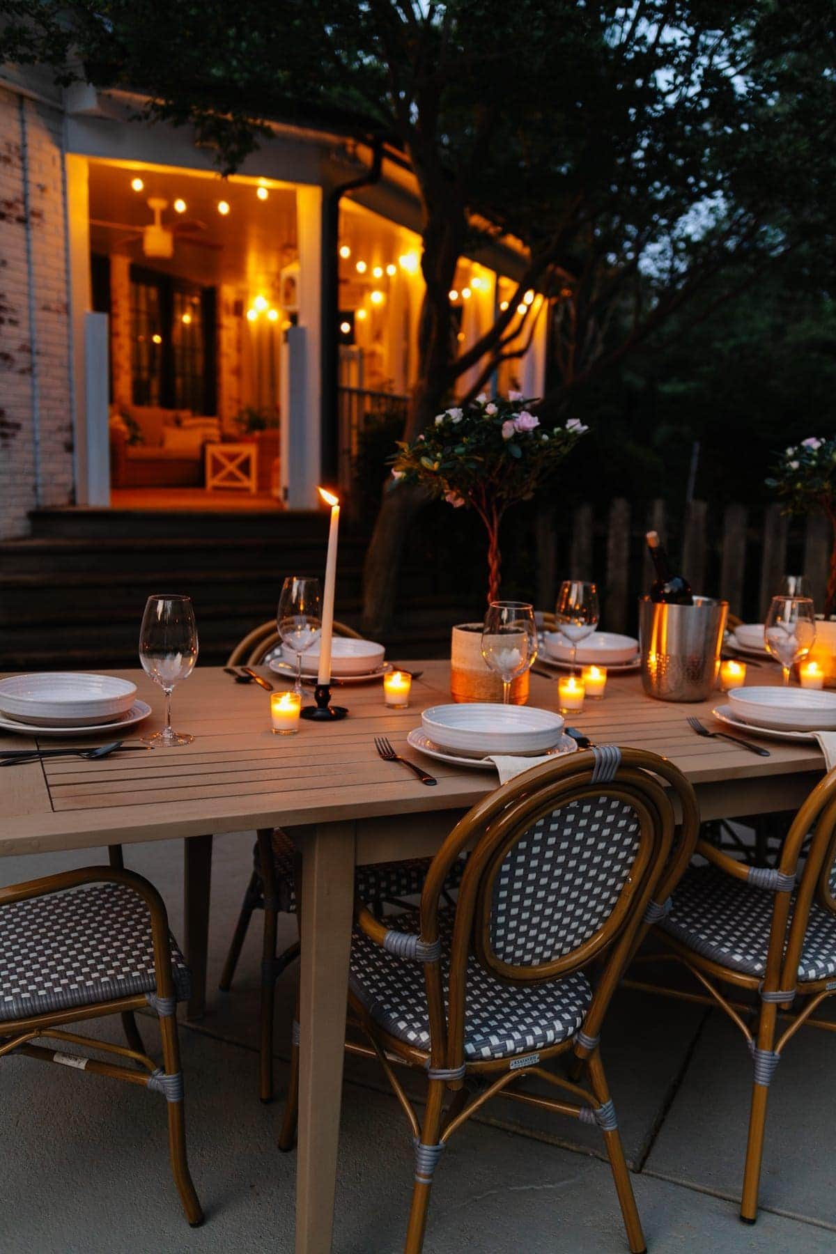night time backyard patio and back porch with string lights and candlelight