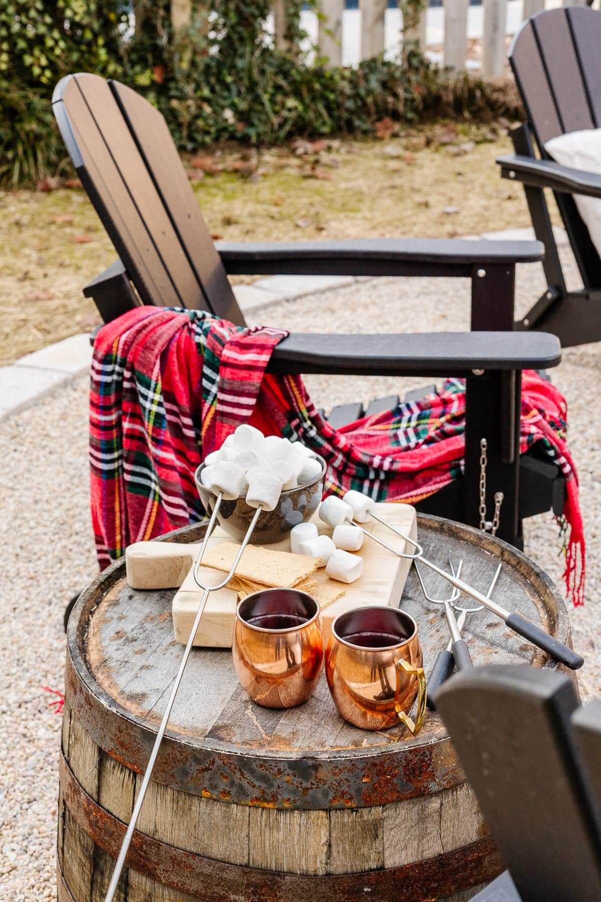 Adirondack chair with barrel side table and s'mores ingredients
