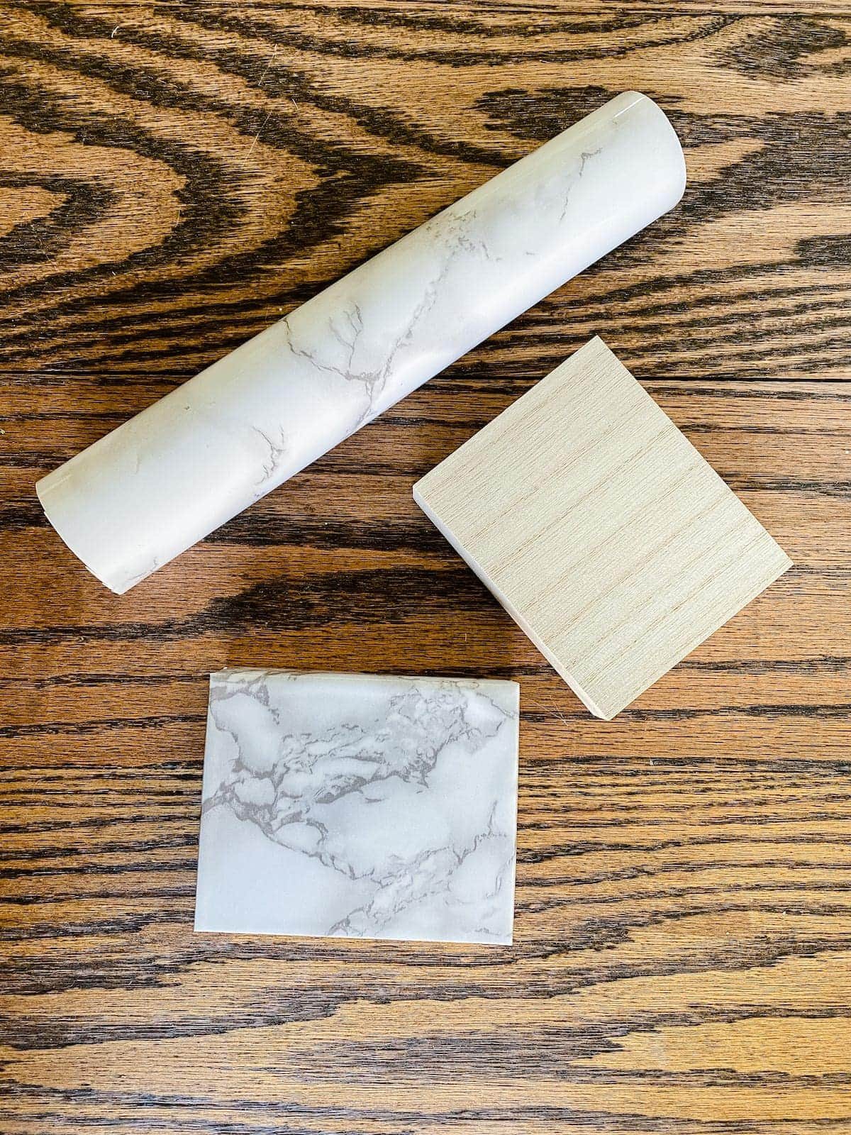 scrap wood block wrapped in marble contact paper