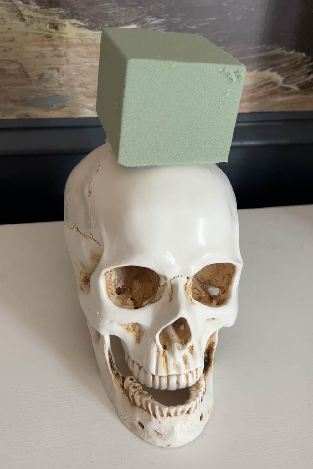 fake skull with floral block foam on top