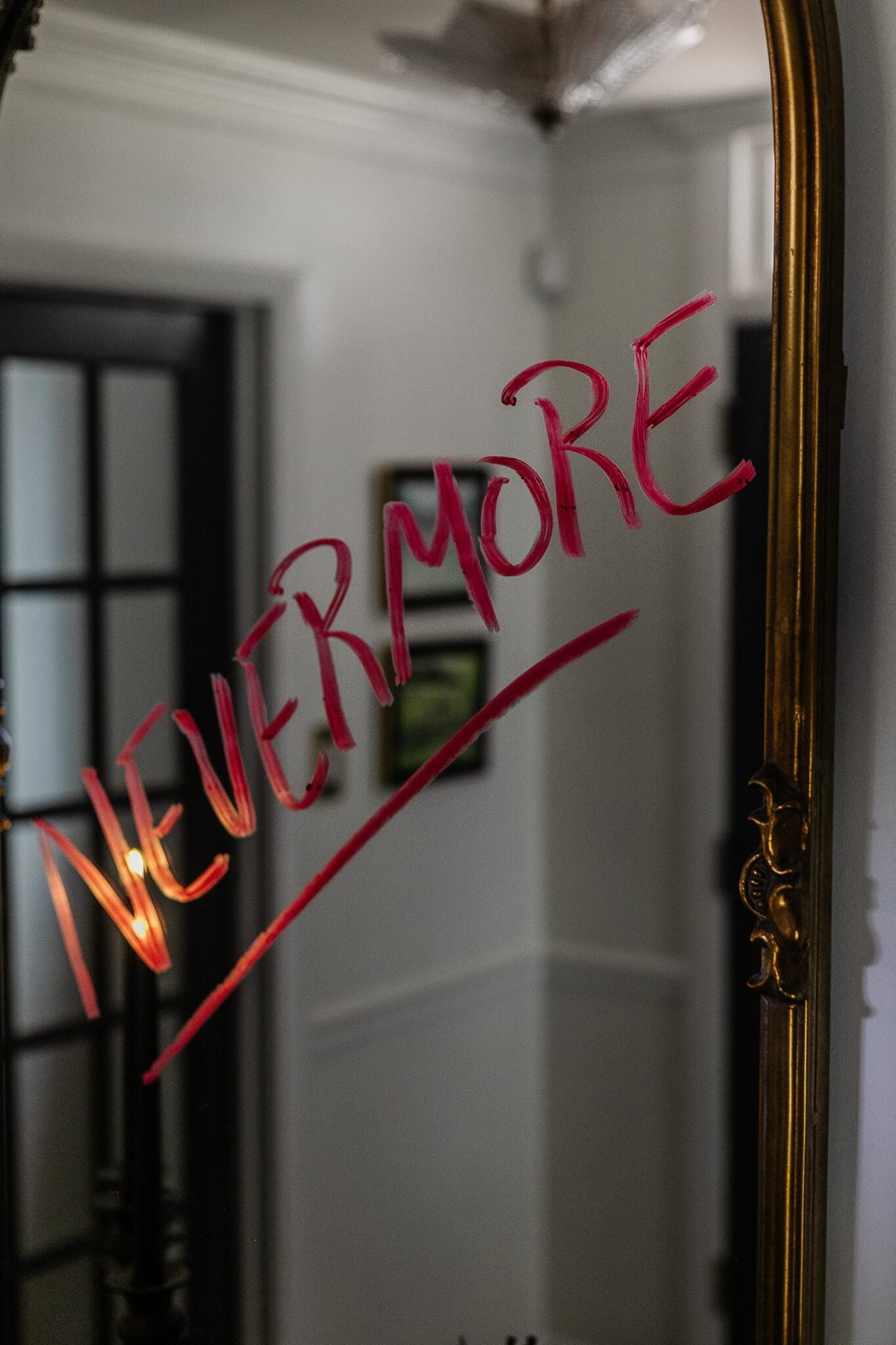 Nevermore written on mirror in red lipstick