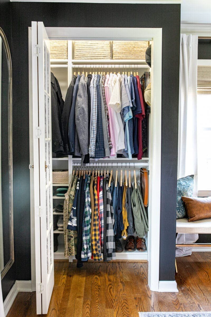built in closet with white shelves and wooden hangers